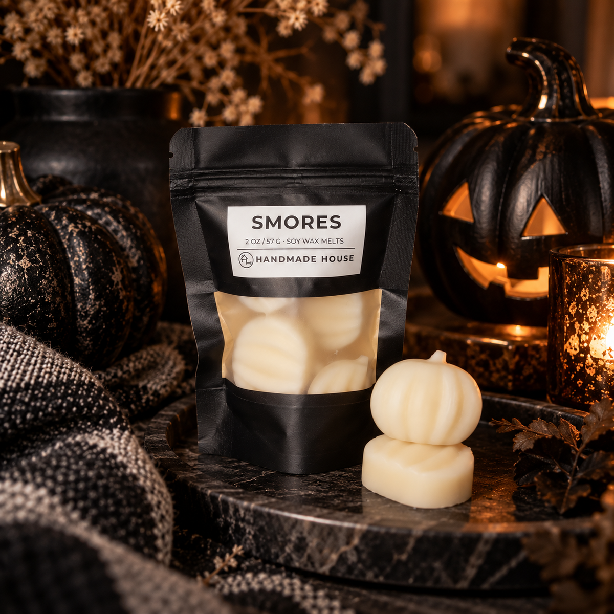 Pumpkin-shaped S'mores soy wax melts in a black resealable pouch