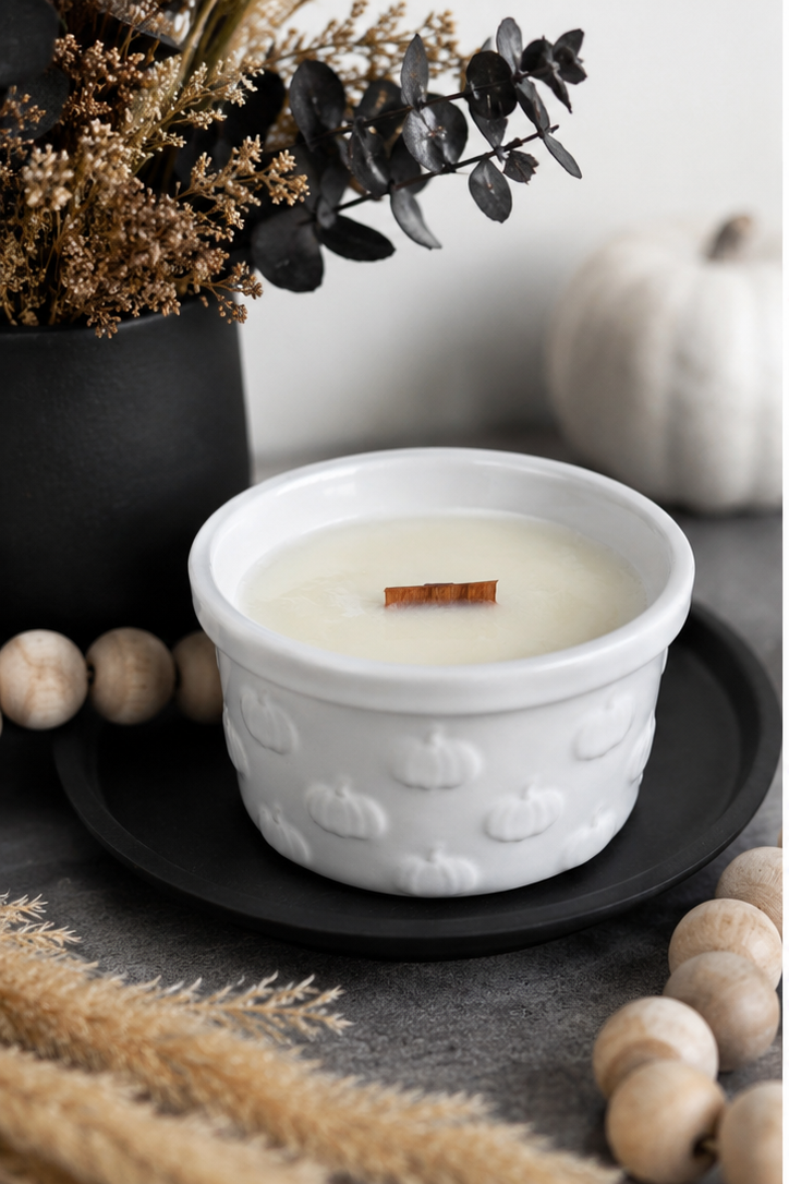 Pumpkin Pie Soy Candle in white ceramic pumpkin-embossed bowl styled with dried botanicals and wood beads